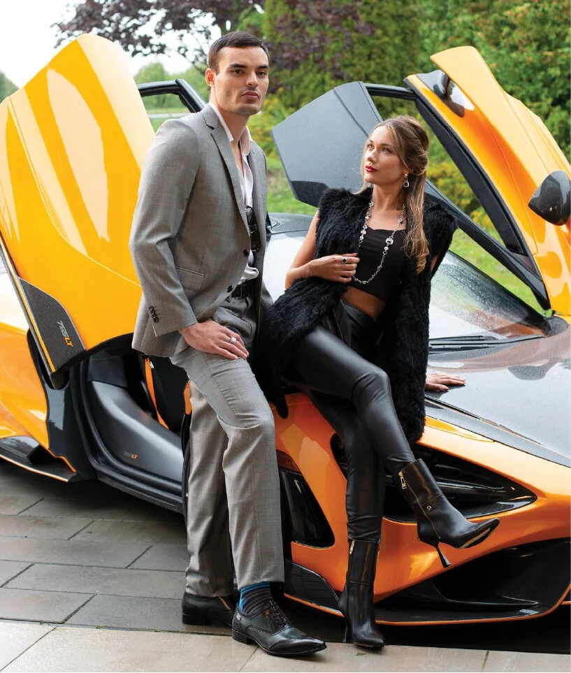 Professional male model and female model standing beside yellow mclaren car