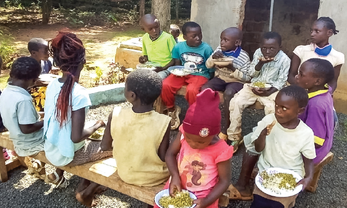 Children grouping together and eating opulence cares food supplies